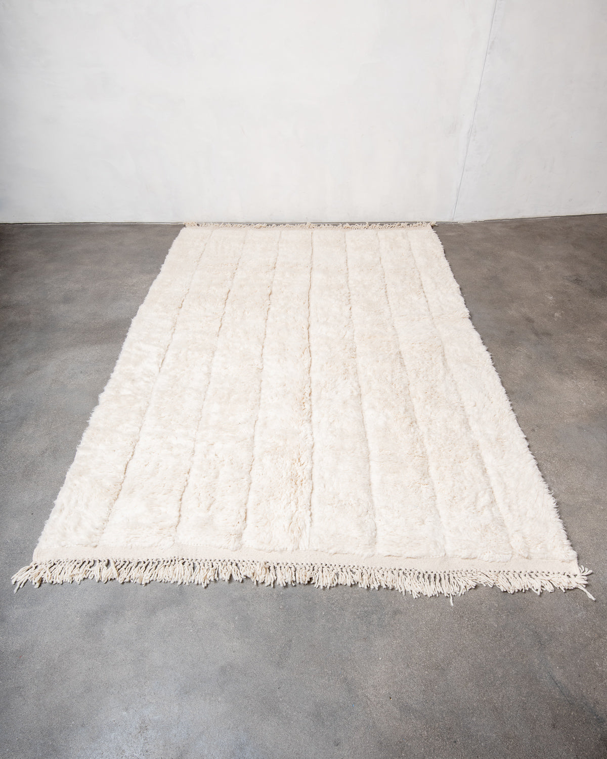 Modern, designer, handcrafted Berber rug from Morocco. Beniourain carpet with minimalist design, natural wool pile and a fluffy texture.